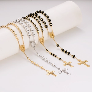 Vintage stainless steel rosary necklaces with crucifix and medallion pendants on display