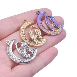 Detailed close-up of crescent moon pendants with Celtic knot texture in gold and silver