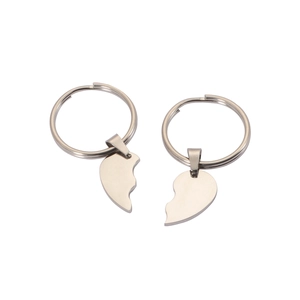 Polished stainless steel heart puzzle keychain set for couples on white background