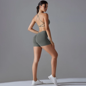 Detail of olive green seamless yoga set featuring a cross-back bra and scrunch leggings