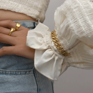 French retro style golden chain bracelet and signet rings set on a female model