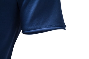 Detailed macro view of dark blue t-shirt sleeve stitching and knit fabric texture