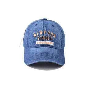 Detail of orange and white New York embroidery on washed denim blue baseball cap