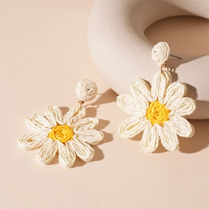 Handcrafted woven daisy earrings with white petals and yellow centers for women
