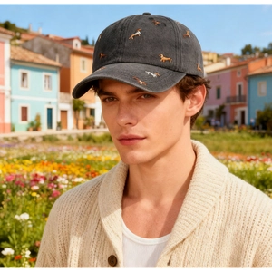 Detail shot of vintage washed dark gray baseball cap with dog embroidery on a model