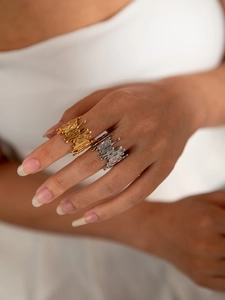 Detailed view of irregular melting metal texture rings in gold and silver finish