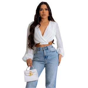 Women's white lantern sleeve wrap cardigan with waist belt and high waist denim jeans