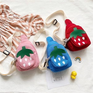 Detail of cute strawberry canvas crossbody chest bags for kids in pink, blue, and red colors