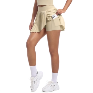 Macro shot of the pleated tennis skort detail showing the functional side phone pocket