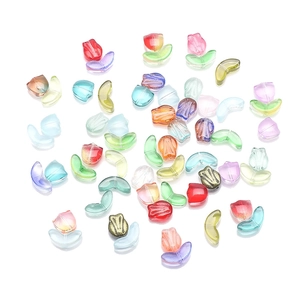 Colorful tulip petal and leaf glass beads set for DIY jewelry making on white background