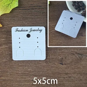 Close-up of 5x5cm vanilla paper earring display card with textured finish and holes