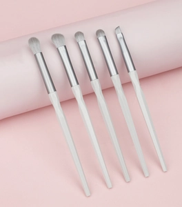 Detail of 5-piece eye makeup brush set with white faceted handles and silver ferrule