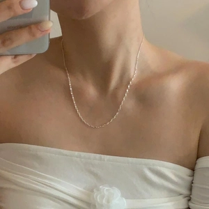 Detailed view of an S925 sterling silver mariner link necklace on a model