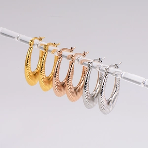 Textured U-shaped hoop earrings in gold, silver, and rose gold with wave patterns