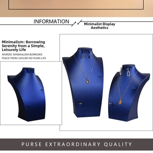 Detail of dark blue satin jewelry bust stand set showing elegant necklace display texture
