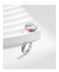 Detail of silver S925 earrings with square rainbow cubic zirconia on white display