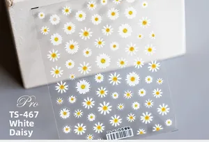 Macro detail of TS-467 5D white daisy nail art stickers on transparent backing film