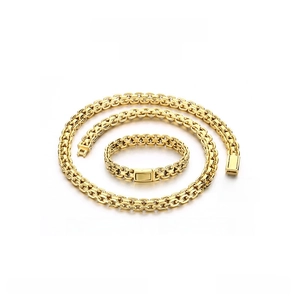 Flat lay of 10mm golden stainless steel chain necklace and bracelet set on white background