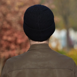Men's navy blue ribbed knit beanie with turnover cuff shown in an outdoor setting