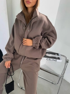 Detail of dark brown loungewear set featuring a zip-up stand collar and matching sweatpants