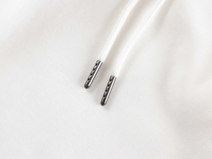 Detailed macro view of high-quality white cotton drawstring with gunmetal tips