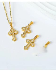 Detail of gold-plated cross pendant with micro-pave zircons and smooth metallic back