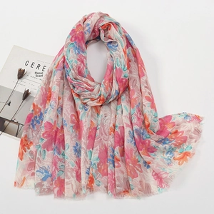 Detail of pink floral voile scarf with fringe edges next to minimalist lifestyle props