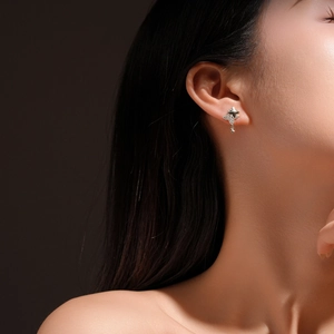 Elegant s925 sterling silver star stud earrings with dangling charms on a female model