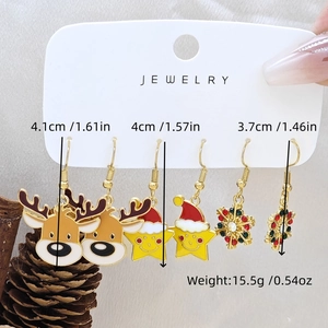 Macro view showing Christmas earring set with reindeer, star and snowflake dimensions