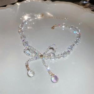 Close-up of butterfly crystal necklace with faceted beads and teardrop pendants