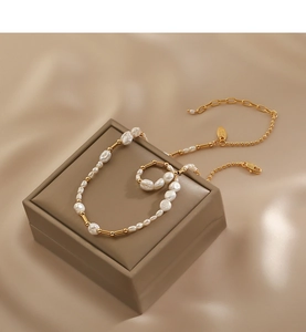 Detailed macro view of baroque freshwater pearls and golden metal beads on necklace