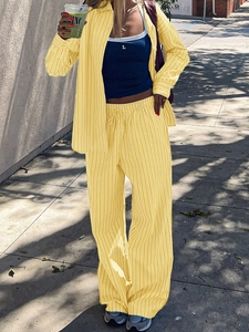 Women's casual yellow striped shirt and wide-leg trousers set for stylish vacation wear