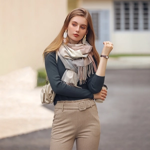 Stylish soft faux cashmere plaid scarf with tassels styled on a model for winter fashion