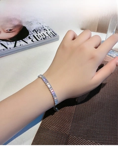 Detail of adjustable silver bracelet with radiant rectangular zircon stones on wrist