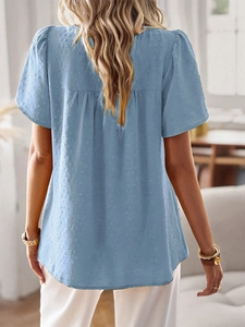 Detail shot of blue short sleeve top featuring 3D Swiss dot textured fabric on the back