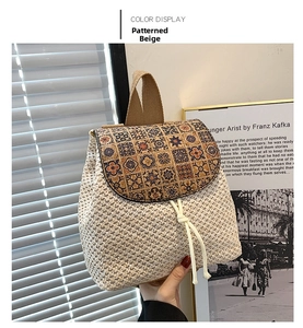 Detailed macro shot of patterned beige woven straw bag with floral print and white drawstrings