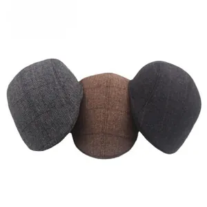 Detailed view of men's winter plaid flat caps in gray, brown, and dark gray colors