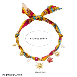 Detailed view of scarf necklace with sun charms and dimensions in inches and centimeters
