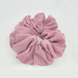 Close-up of soft mauve chiffon fabric texture on a high-elastic scrunchie hair tie