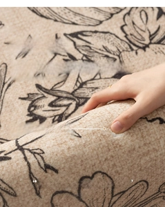 Detail view of thick beige vintage carpet showing dense woven pile and floral pattern
