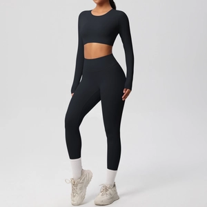 Full body view of a black long-sleeve crop top and high-waist yoga leggings set