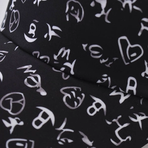 Close-up of street style baseball cap with white heart print and high-density fabric detail
