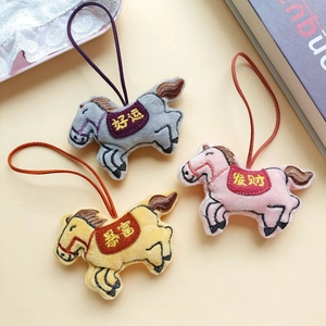 Close-up of plush horse charms with Chinese embroidery of prosperity and good fortune