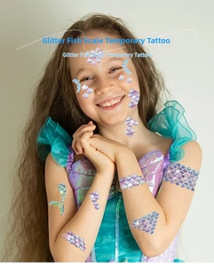 Close-up of glitter mermaid scale temporary tattoos on a child skin for parties