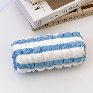 Detail of blue and white striped puffy pencil case with soft ruffle texture and zipper