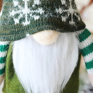 Detailed close-up of Christmas gnome wine topper with green knit hat and snowflake pattern