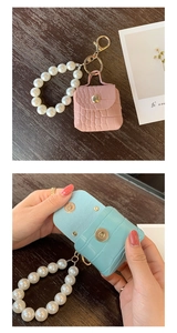 Detailed view of faux crocodile leather mini bag charm with pearl strap and gold carabiner