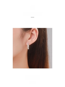 Close-up of minimalist S925 sterling silver hoop earrings with pave-set zircon stones