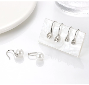 Macro detail of S925 sterling silver ear hooks and pearl settings for jewelry making