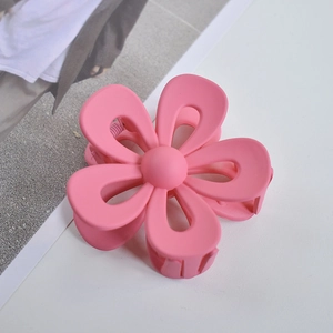 Detailed view of the pink matte flower hair claw clip with its durable grip structure
